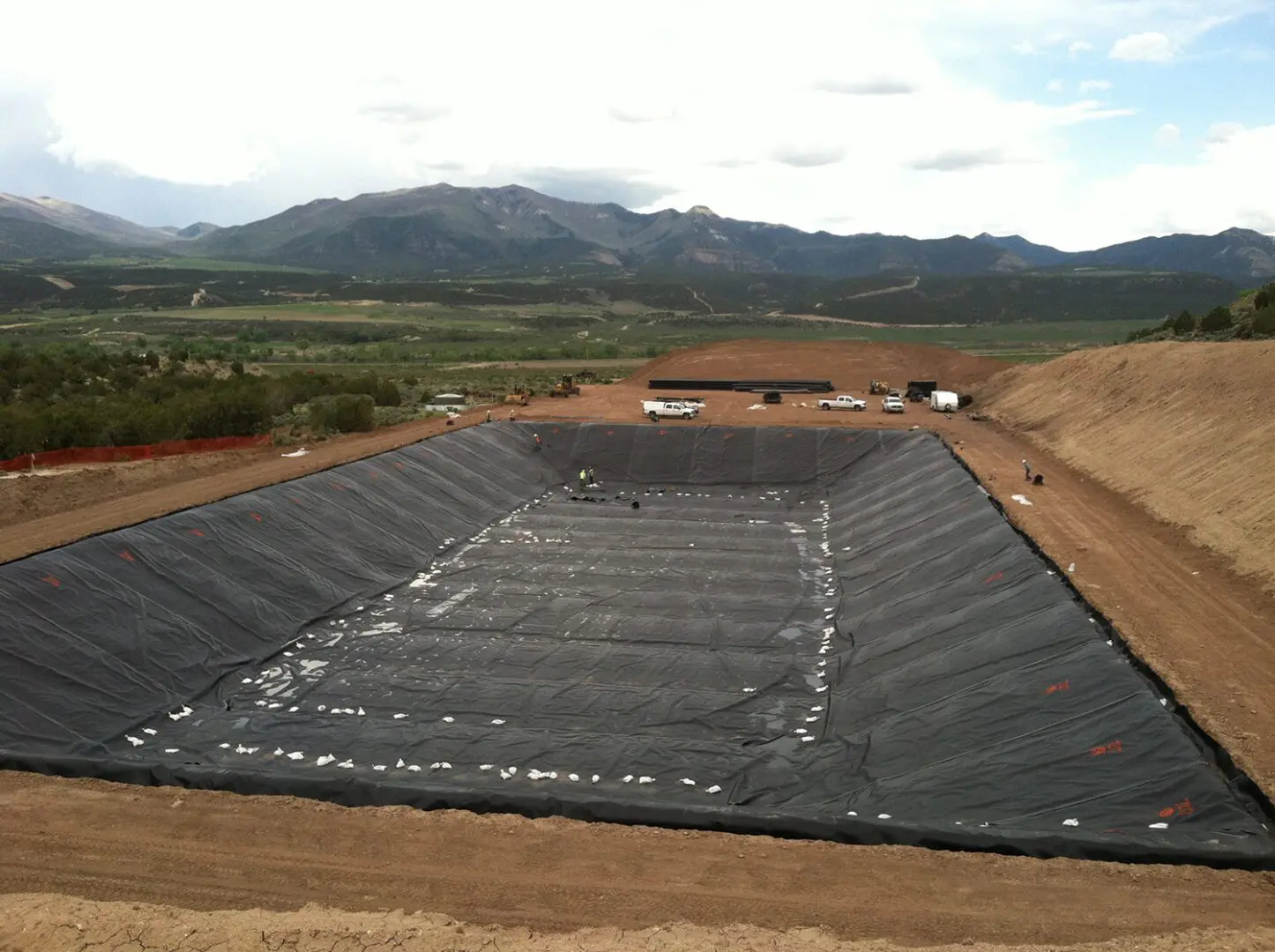 A large area of ground that has been covered with black plastic.