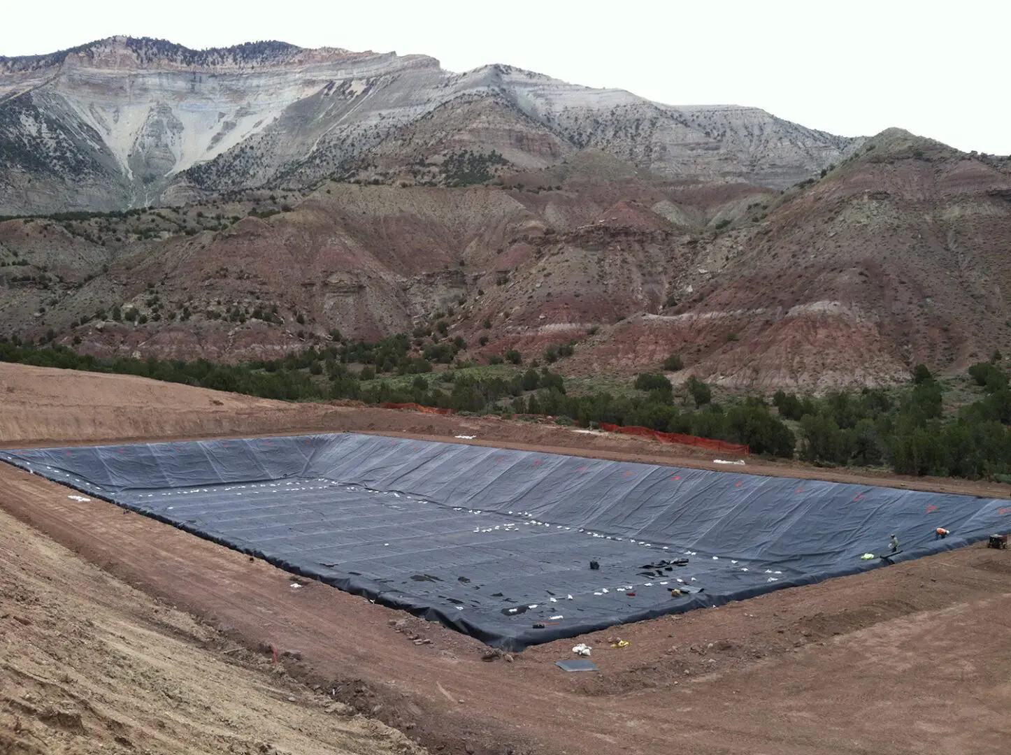 A large black tarp on top of a hill.