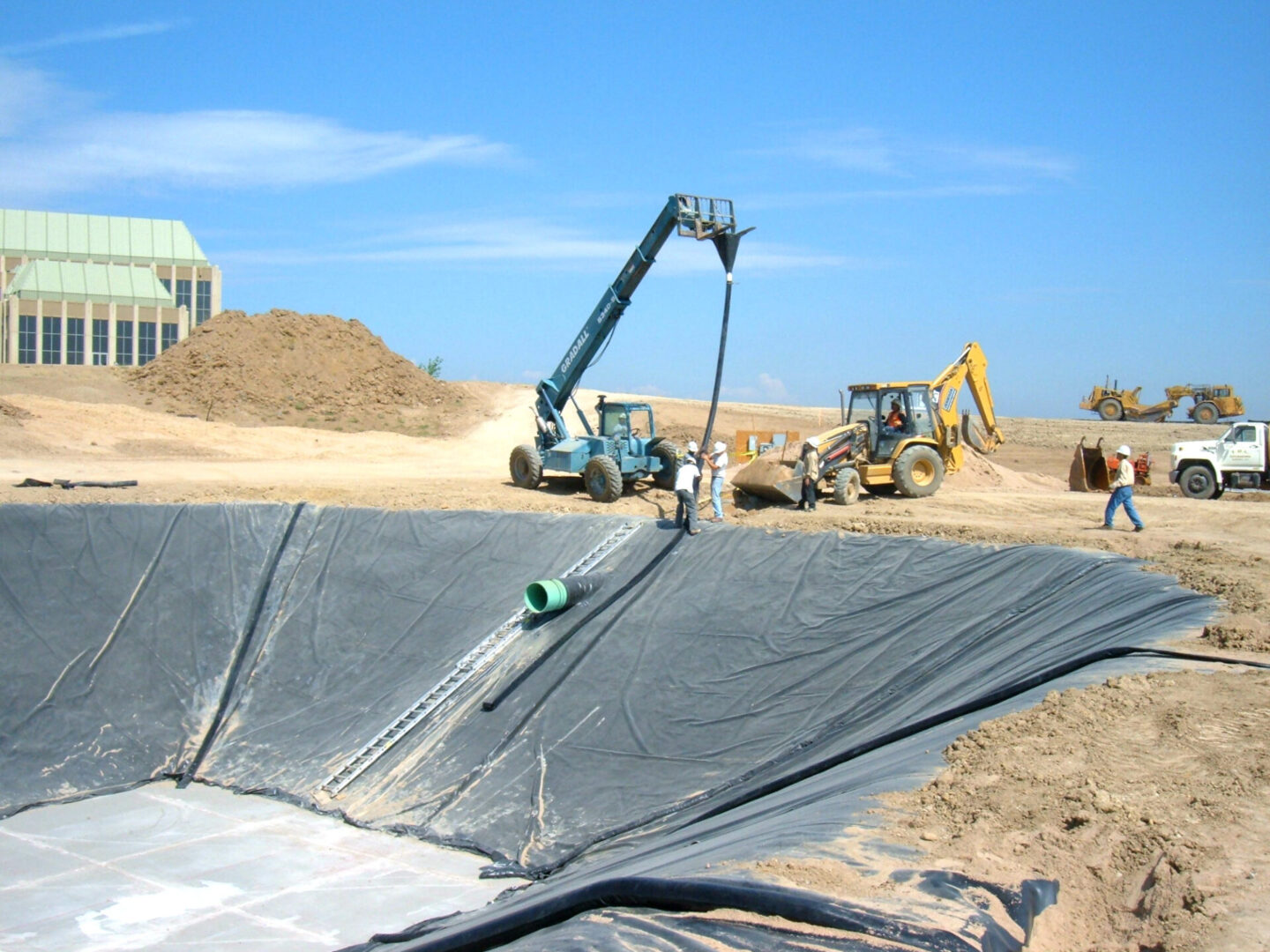 A construction site with machinery and sand.