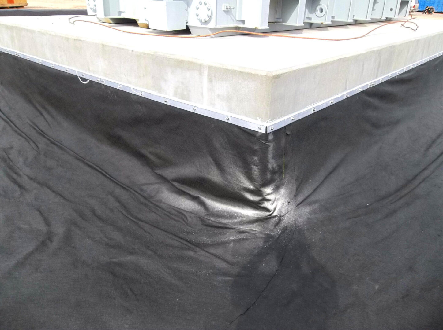 A black tarp covering the top of a building.