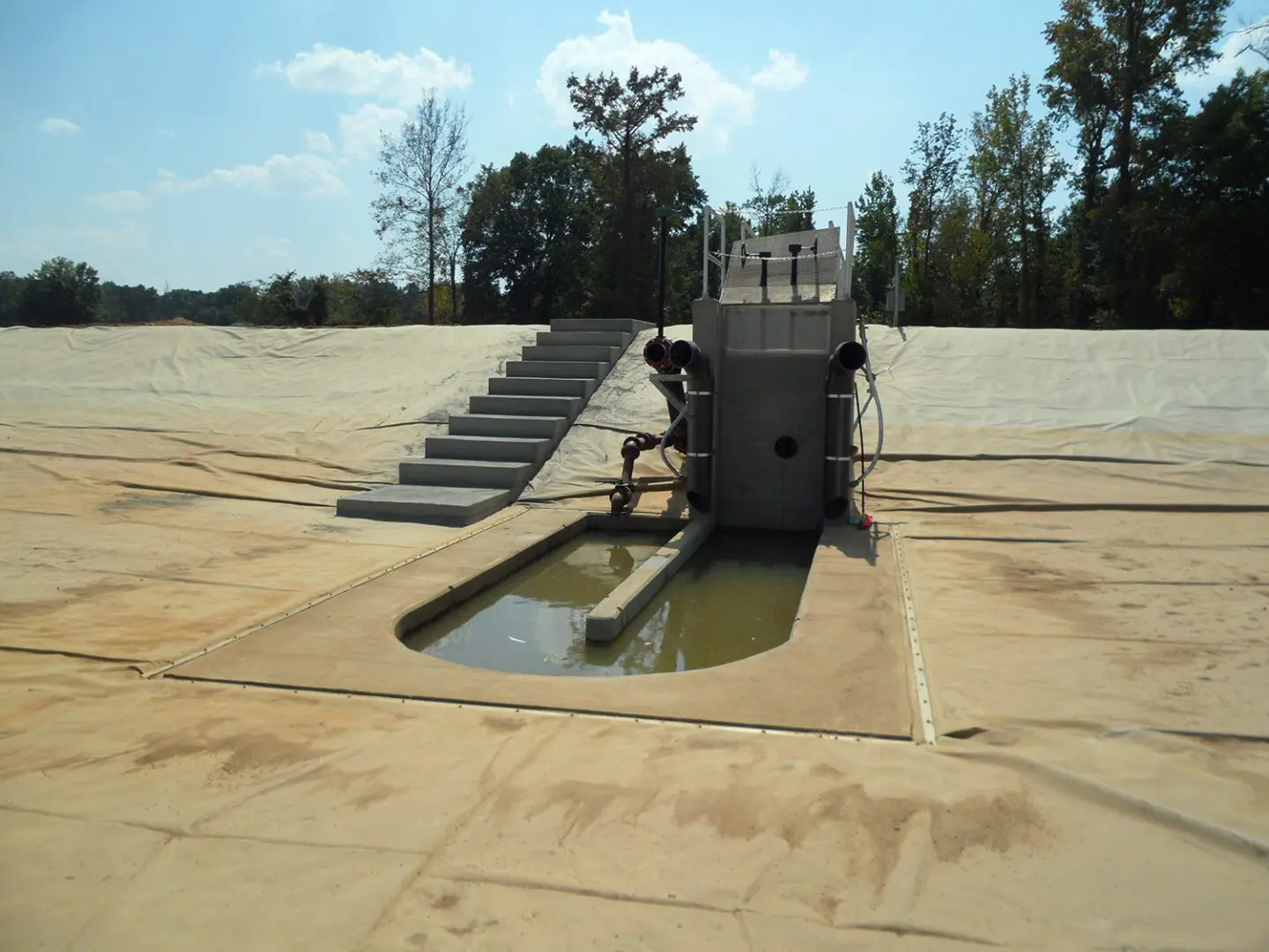 A tank is in the middle of an empty field.