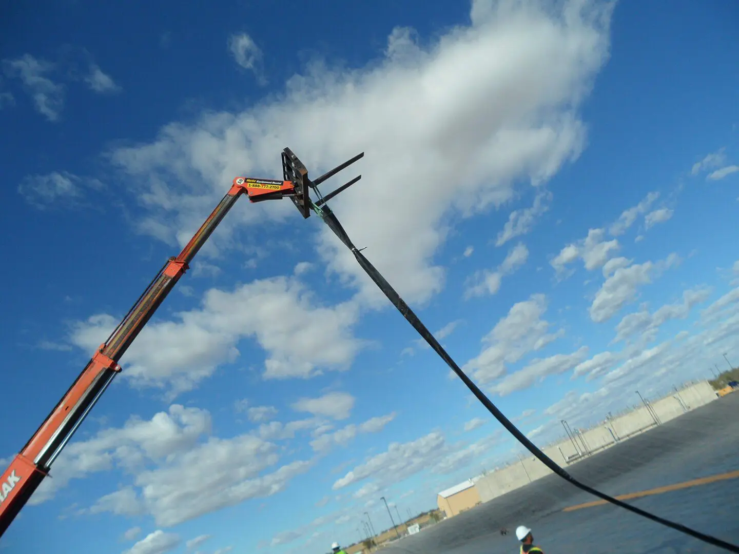 A crane is lifting up the water from the sea.