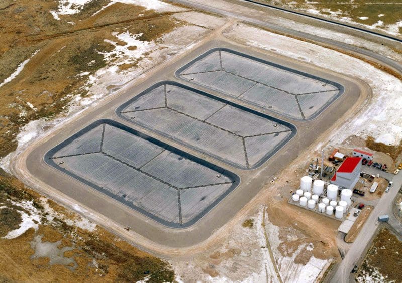A large concrete slab with three large tanks.