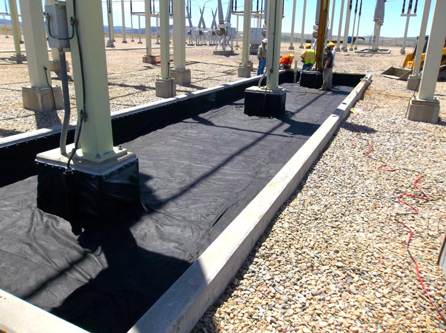 A walkway with black fabric on the ground.