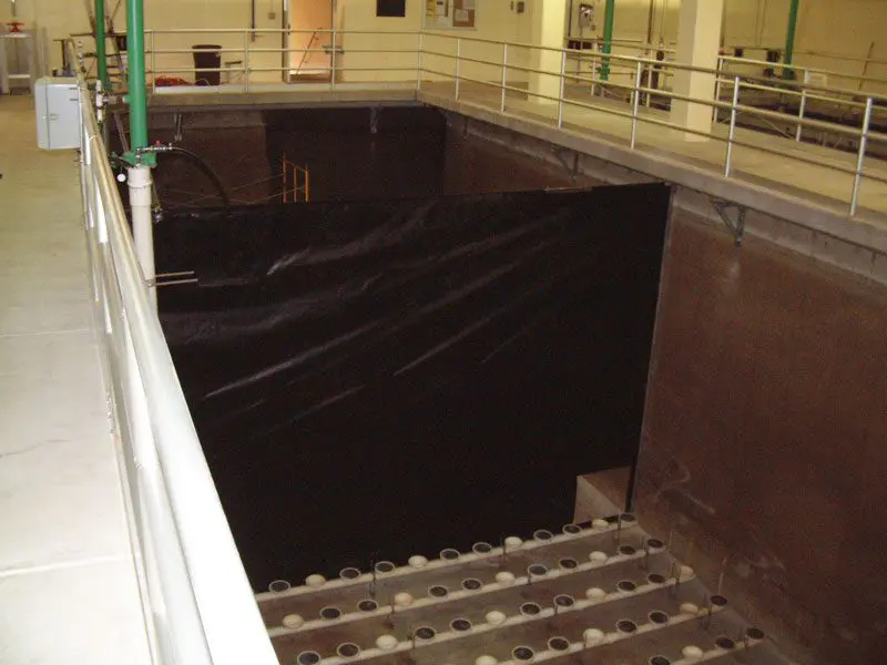 A black tarp covering the bottom of stairs.