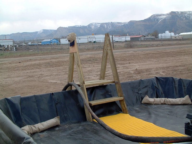 A ramp with steps going up it in the middle of an area.