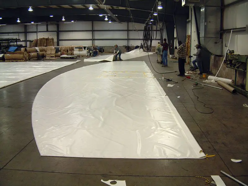 A large white sheet is being worked on.
