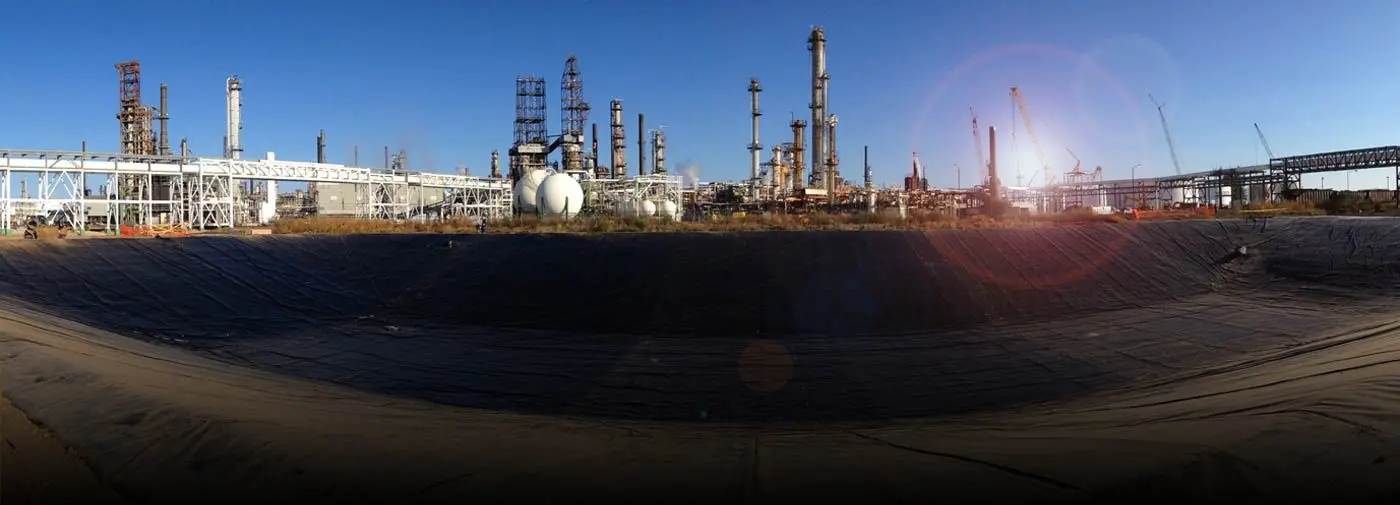 A large oil refinery with many towers and tanks.